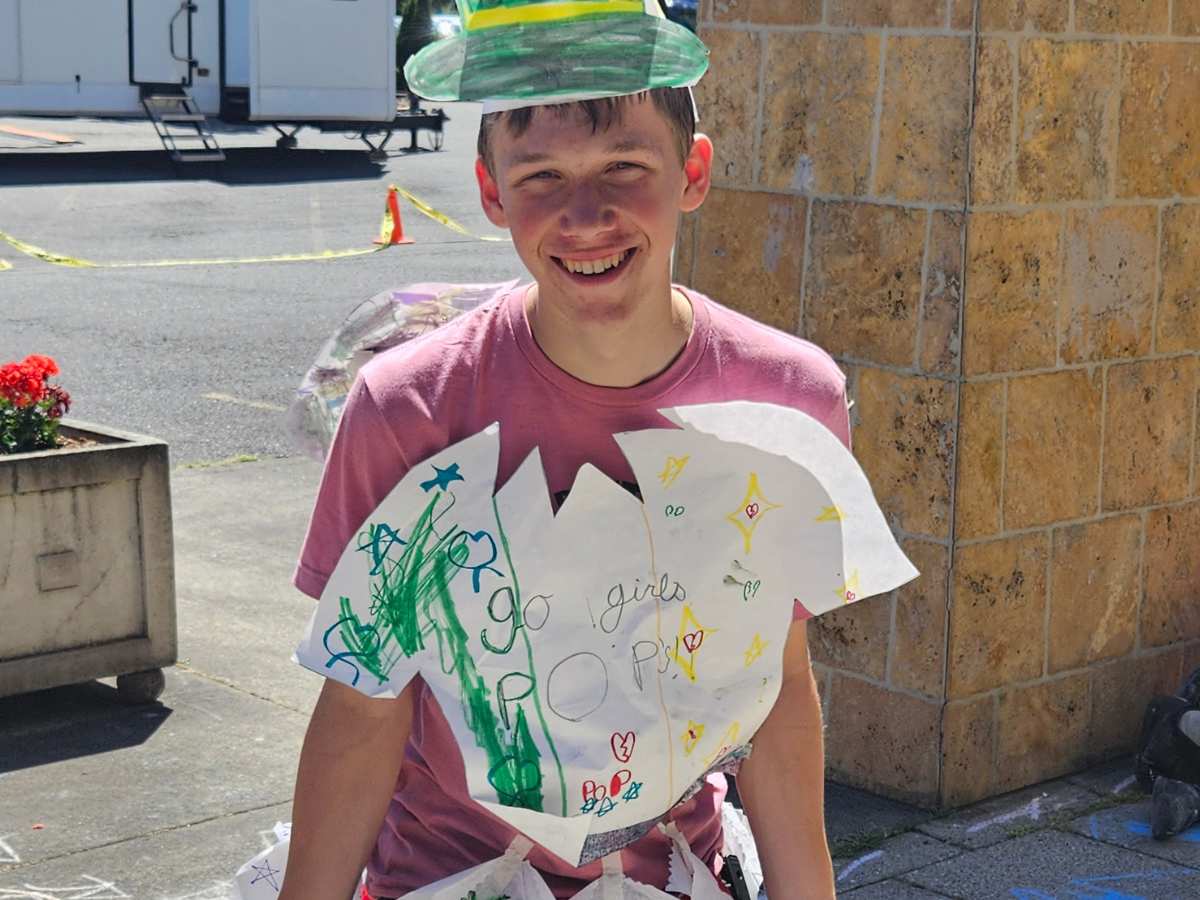 Counselor smiling while in costume that campers made out of paper