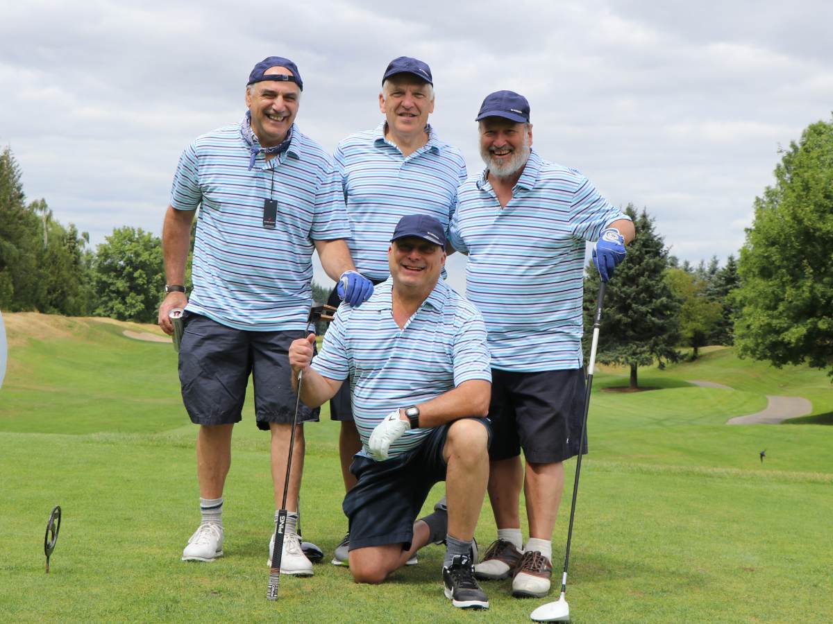 A team of golfers wearing matching clothes