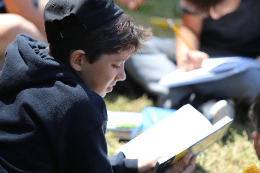 Kid reading at camp